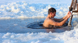 Man Climbing out of a ice hole after doing a cold plunge